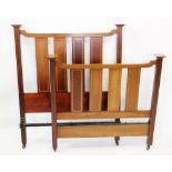 A pair of Edwardian mahogany slatted single beds, with satinwood crossbanded vertical rails,