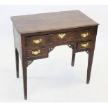 A George III oak lowboy, the rectangular moulded three plank top above an arrangement of one long