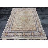 A Persian pattern wool rug, with a central circular medallion on a foliate and taupe ground,