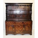 A mid 18th century oak North Walian dresser, the moulded cornice above a shaped frieze and three