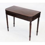 A George III mahogany tea table, the 'D' shaped hinged top raised upon a tapering ring turned