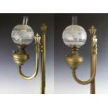 A pair of Victorian brass ecclesiastical wall mounted oil lamps, the tapering hexagonal supports