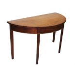 An early 19th mahogany D-end side table, raised upon legs of tapering square section,