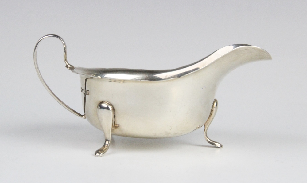 A silver sauce boat by Emile Viner, Sheffield 1963, of typical form with shaped rim and C-shaped