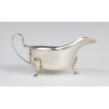 A silver sauce boat by Emile Viner, Sheffield 1963, of typical form with shaped rim and C-shaped