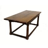 A 17th century style oak refectory table, early 20th century, the cleated three plank top raised