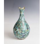 An Ottoman Empire Iznik bottle vase, turquoise glazed, 29.5cm high (at fault)