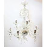 An early 20th century eight branch glass chandelier, the baluster shaped stem extending to eight 'S'