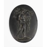 A Wedgwood black basalt oval plaque, 19th century, depicting Hercules carrying the Erymanthian Boar,