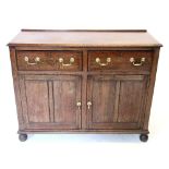 A 19th century oak dresser base/sideboard, the rectangular moulded top above two frieze drawers