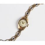A lady's vintage 9ct gold Accurist wristwatch, the round cream dial with Arabic numerals and baton