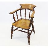 A 19th century elm and beech wood smokers bow elbow chair, the 'C' shaped arm rest with scrolled