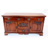 A late Victorian walnut sideboard, the rectangular moulded top above a pair of frieze drawers,