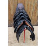 Five assorted leather saddles, to include a pony saddle with leathers and irons, 37cm long,