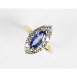 A sapphire and diamond cluster ring, the central marquise cut sapphire (measuring 13mm x 5.5mm x 3.