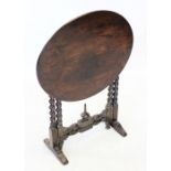 A 19th oak folding occasional table, the circular top raised upon barley twist legs extending to