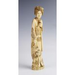 A large Japanese signed ivory okimono, Meiji period (1868-1912), designed as a geisha modelled in