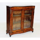 A Victorian ebonised and burr thuya glazed bookcase, the pagoda shaped top above a pair of glazed
