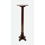 An early 20th century oak torchere, the square moulded top supported on scroll capitals and a