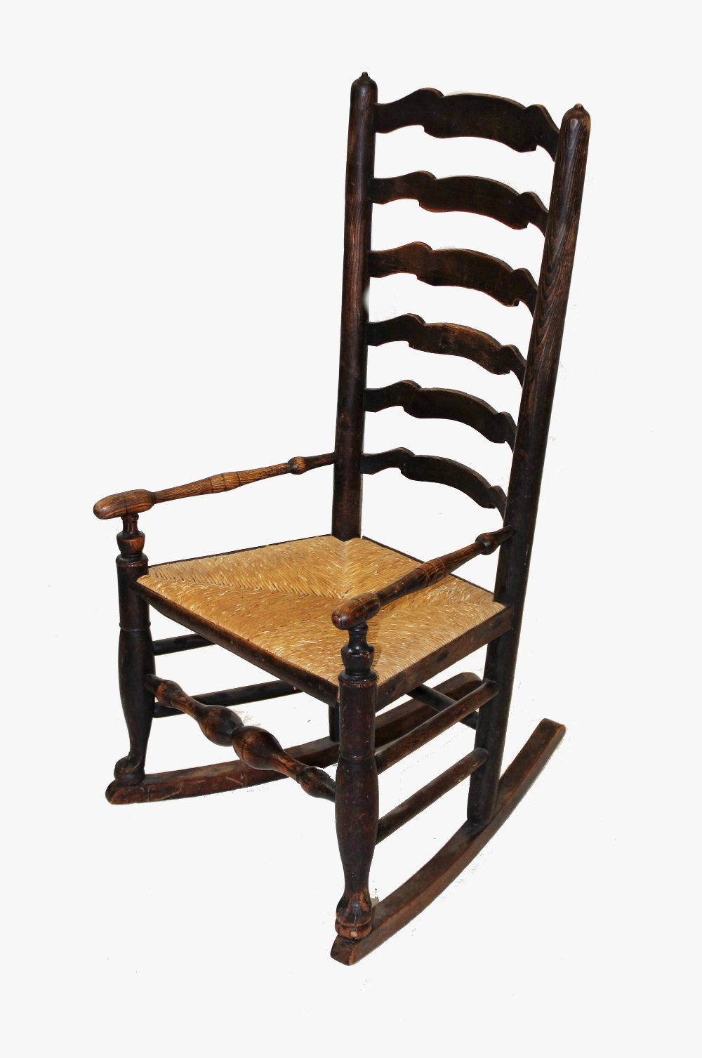 A late 18th/early 19th century ash Lancashire ladder back rocking chair, the six shaped rungs