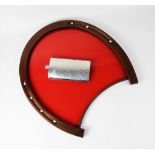 A novelty drinks tray in the form of a horseshoe, with metal nail details and red acrylic