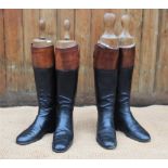 A pair of Peal and Co Ltd leather hunting boots, black and tan, with Peal & Co trees and another