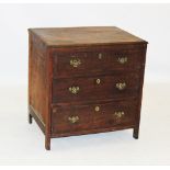 A George III oak and mahogany cross banded chest of three drawers, the rectangular moulded top above