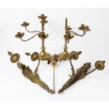 A pair of brass neo-classical style twin branch wall sconces, 20th century, the urn finials with