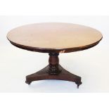 A William IV mahogany centre table, the circular tilt top raised upon a substantial ring turned