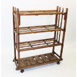 A mid 20th century rustic pine slatted shoe rack, the slatted shelves supported on rough cut