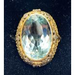 An aquamarine ring, the central oval mixed cut light blue aquamarine measuring approximately 23.