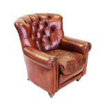 A George III style chestnut brown leather club armchair, late 20th century, the concave button