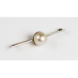 An untested pearl set brooch, the central pearl (measuring approximately 12mm diameter) within a