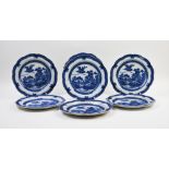 A set of seven English blue and white plates, early 19th century, each decorated in the Chinese