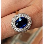 A sapphire and diamond cluster ring, the central oval, mixed cut sapphire (measuring approx 3.16ct),