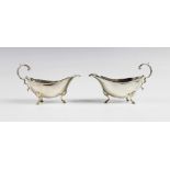 A pair of Edwardian silver sauce boats by Walker and Hall, Chester 1909, each of typical form with