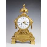 A late 19th century French gilt metal mantel clock, the case surmounted with an urn shaped finial,