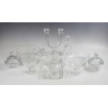 A selection of cut glass pieces, comprising a twin branch candelabra, 24cm high, two covered