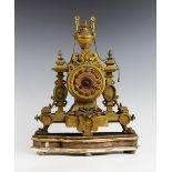 A late 19th century French ormolu mantel clock by Brevete SGDG, with a urn shaped finial above the