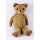 An early 20th century golden plush growler bear, with articulated limbs, 75cm high