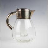 A silver plated cut glass lemonade/cocktail jug, of faceted baluster form, plain polished mount with