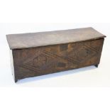 A mid 17th century oak six plank sword chest/coffer, the hinged cover with a moulded border