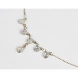 An Edwardian style moonstone fringe necklace, comprising six polished moonstone cabochons, each
