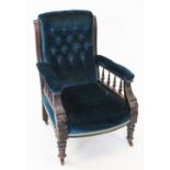 A Victorian walnut and upholstered drawing room chair, the upholstered arms raised upon turned