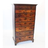 A George III tall mahogany chest of drawers, the moulded cornice above eight graduated drawers