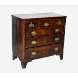 An early 19th century mahogany chest of drawers, with an arrangement of three short over three