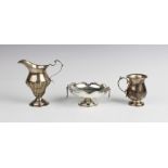A Victorian silver cream jug, London 1894 (maker's mark worn) of baluster form with half-reeded