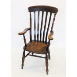 A Victorian elm and beech wood Windsor farmhouse elbow chair, the lath back above a shaped elm seat,