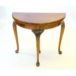 A George II style mahogany folding games table by Waring and Gillow, early 20th century, the demi