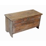 An 18th century pine six plank coffer, the rectangular moulded top opening to a fitted candle box,